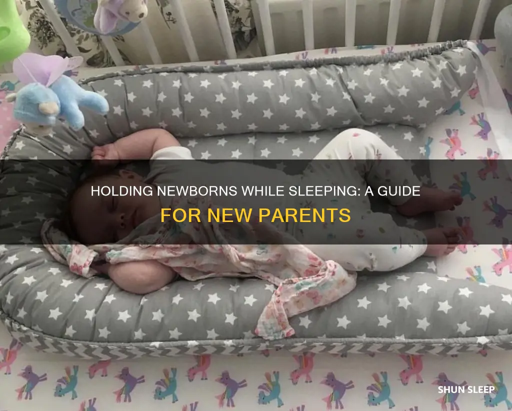 how to sleep holding a newborn