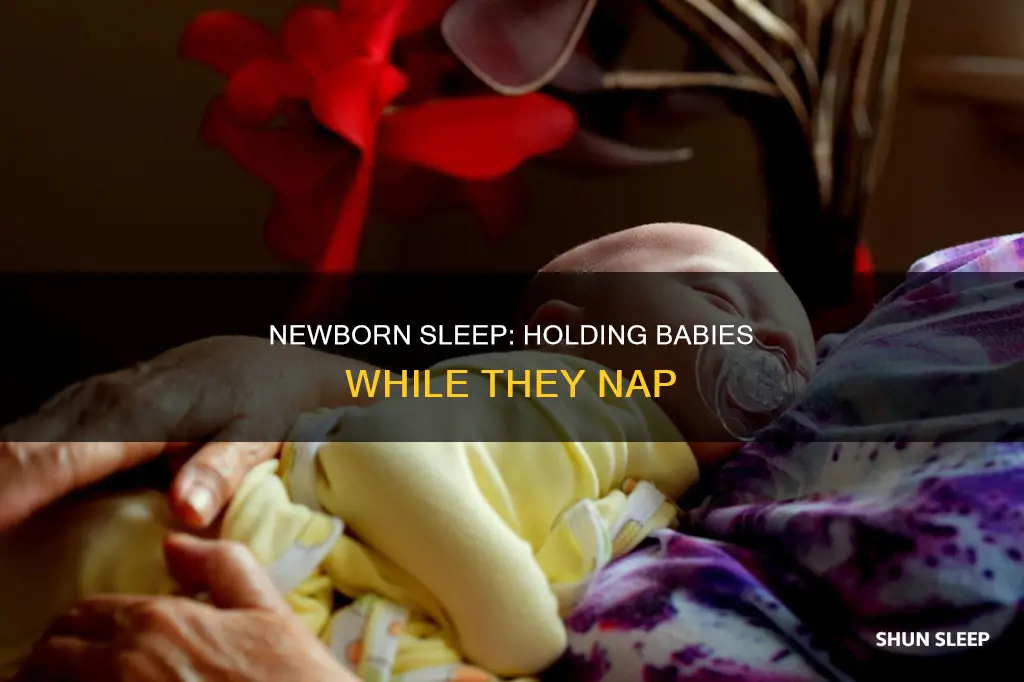 should you hold newborns when they sleep