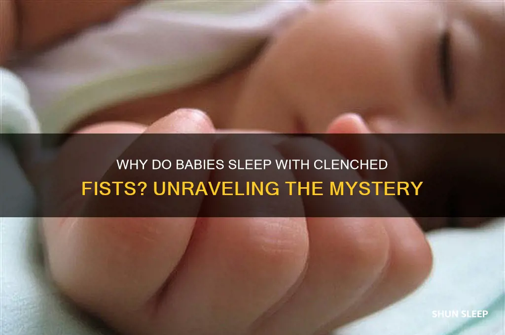 why do babies sleep with clenched fists